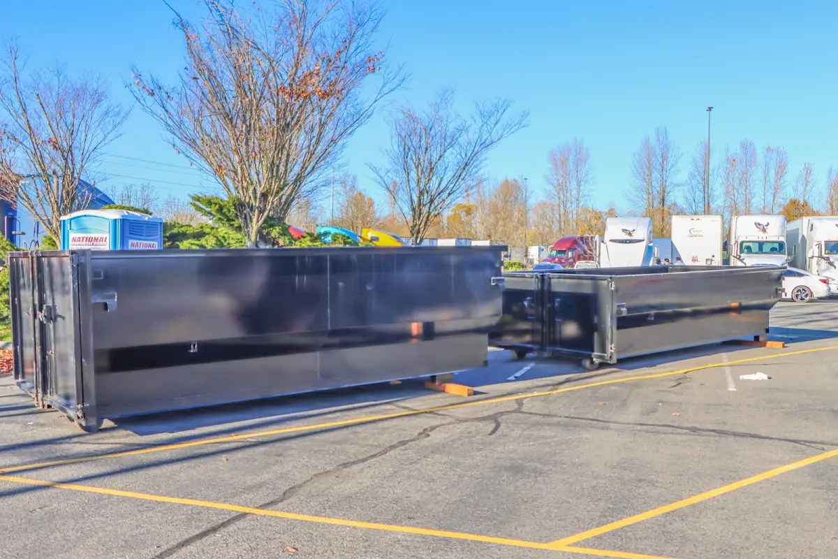 Professional dumpster rental service with roll-off container on residential driveway in Parma Heights